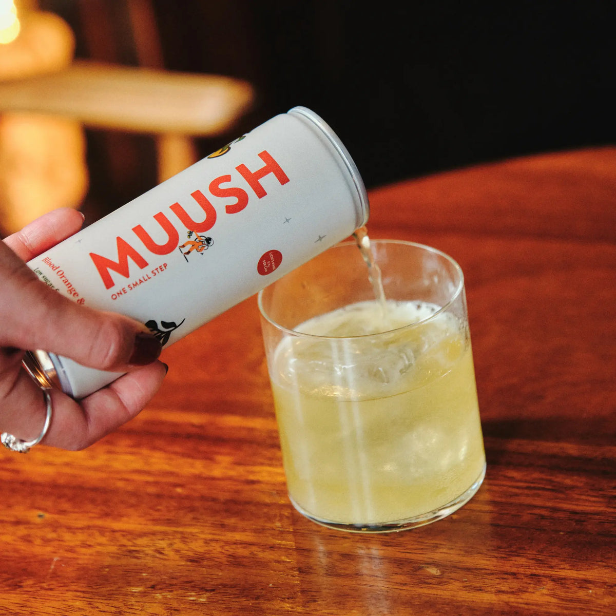 MUUSH Blood Orange & Ginger 250ml can poured in a glass