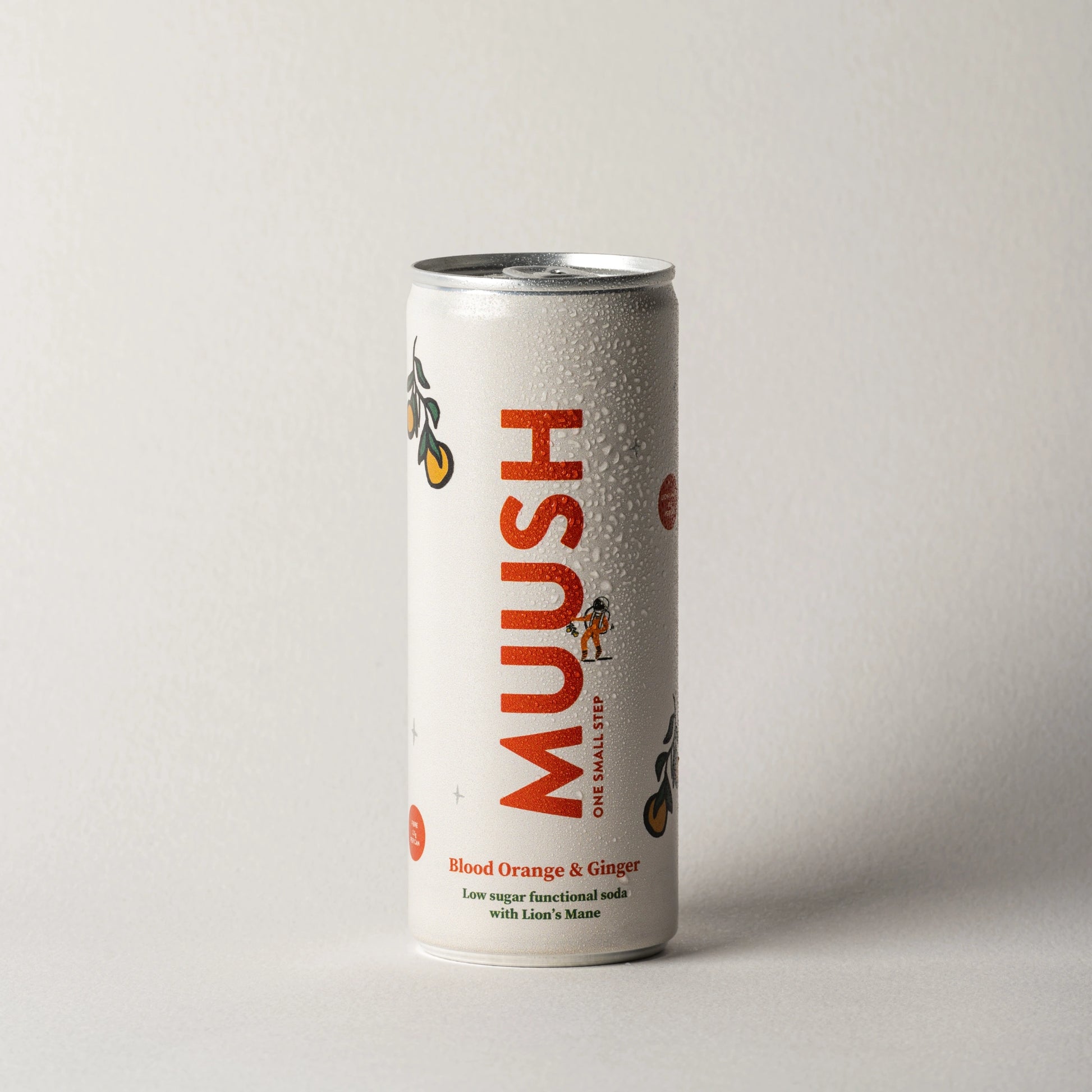 A 250 ml can of  MUUSH low sugar functional soda featuring Blood Orange, Ginger, and Lion's Mane mushroom extract