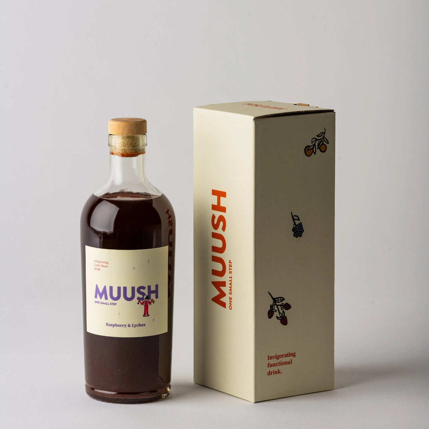 Bottle and box of MUUSH Raspberry and Lychee drink on a gray background