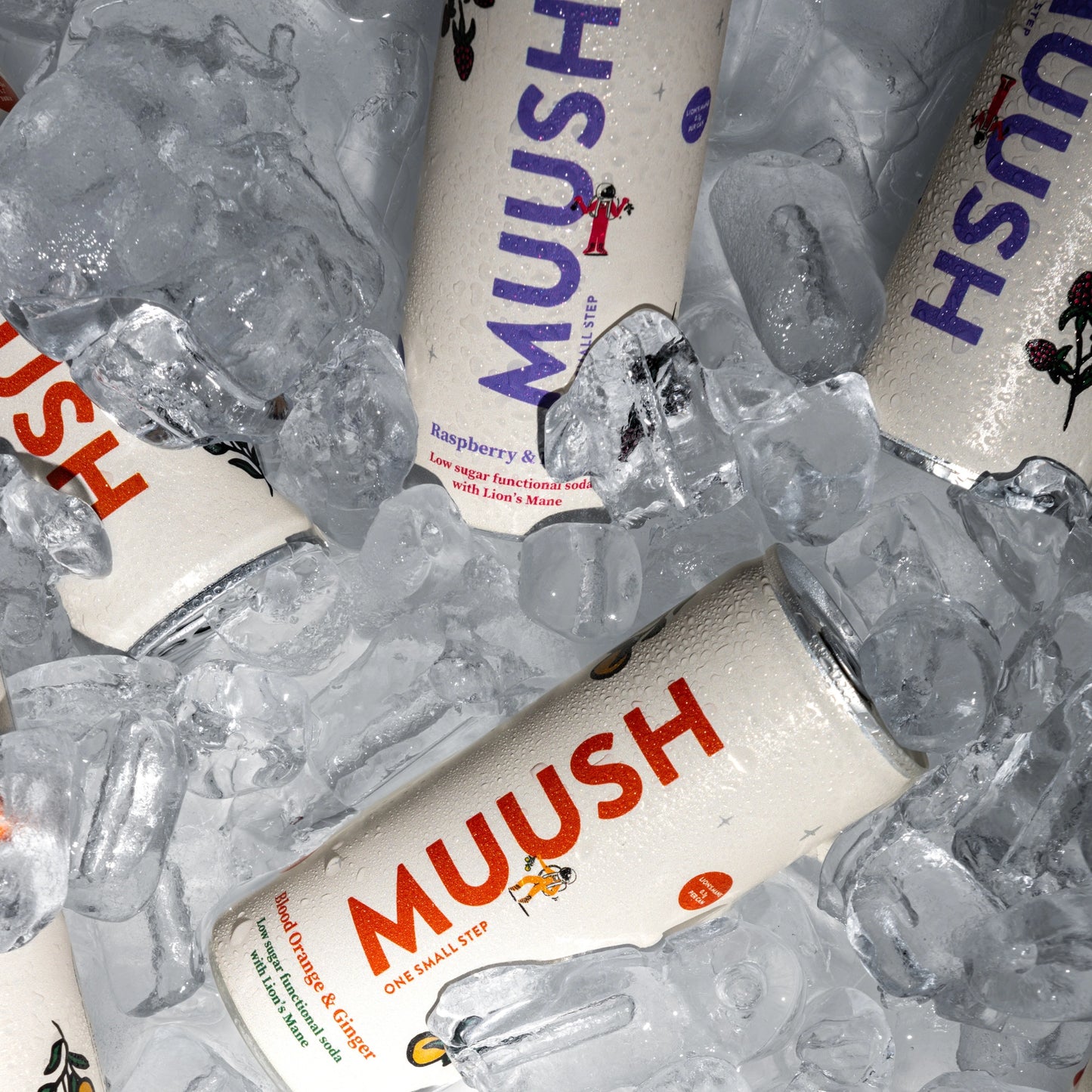 Chilled cans of Mushroom based drink MUUSH in two flavours 'Blood Orange & Ginger' and 'Raspberry & Lychee' on ice cubes